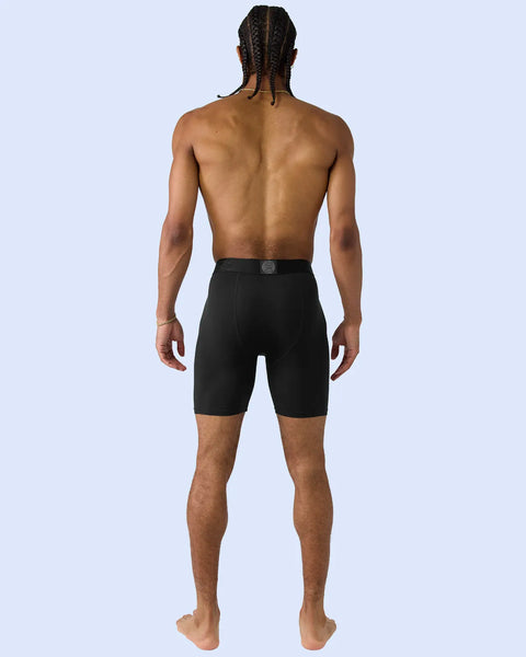 Black modal shorts with elastic waistband and circular logo detail, shown on model from behind.