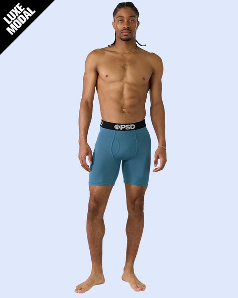 Man wearing teal boxer briefs with black PSD waistband.