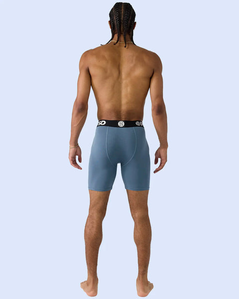 Man wearing teal modal boxer briefs with branded waistband, back view.