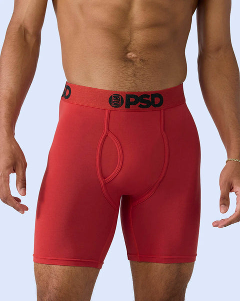 Red modal boxer briefs with black PSD waistband and logo, mid-thigh length.