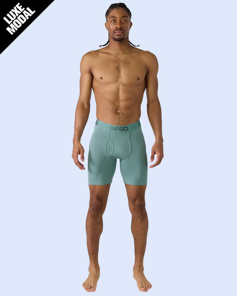 Man wearing jade dust-colored modal boxer briefs with branded waistband.
