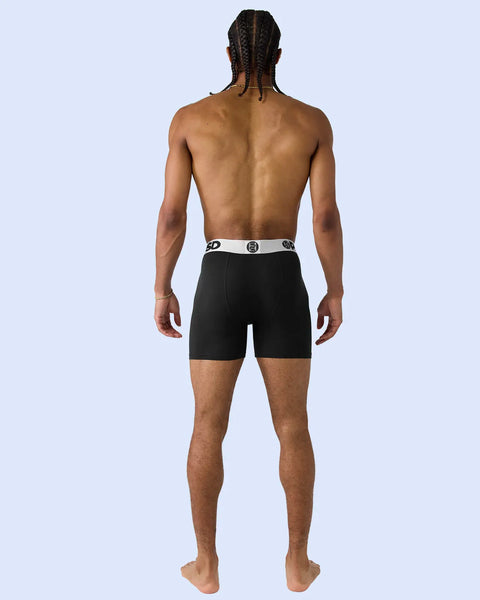Black boxer briefs with silver and black elastic waistband, shown on model from back.