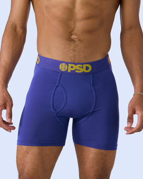Royal blue boxer briefs with yellow PSD waistband worn on model.