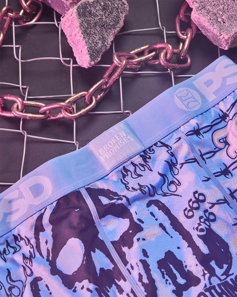 Blue and purple patterned fabric band with text print, pink chain, and gray sparkle elements on dark grid background.