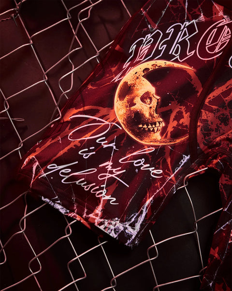 Dark red album artwork featuring a glowing skull, neon grid pattern, white cursive text, and partial neon signage on black ba
