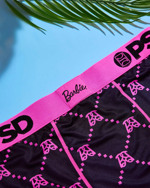 Black and hot pink Barbie monogram underwear with repeated logo pattern and elastic waistband.