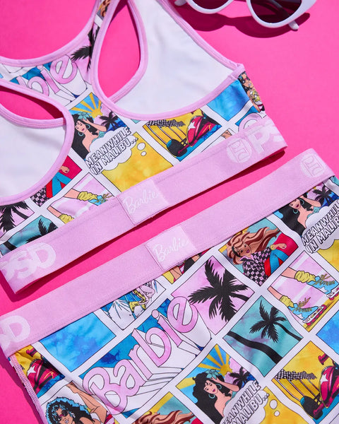 Pink Barbie Malibu swimsuit and matching sunglasses with comic-strip print design on bright pink background.
