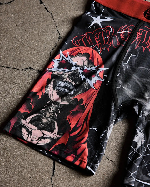 Black and red graphic t-shirt with skull and lightning bolt design on cracked concrete background.