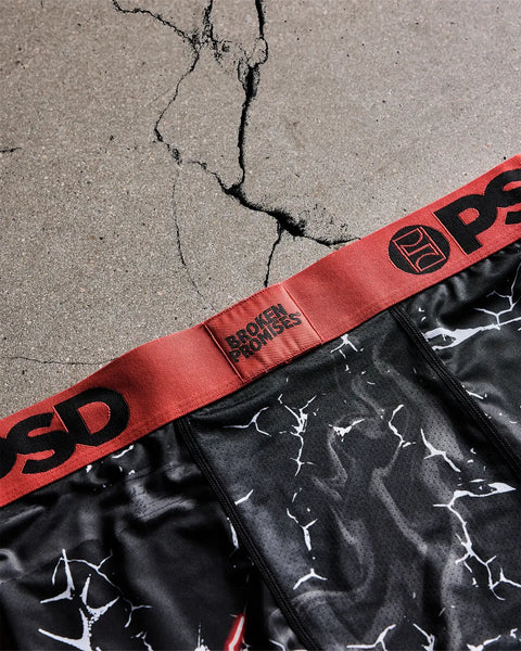 Black underwear with white lightning bolt pattern and red waistband with 