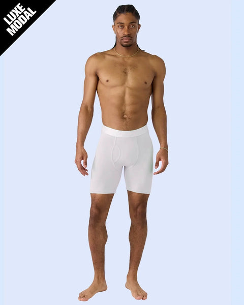 Man wearing white modal boxer briefs with elastic waistband and fitted legs.