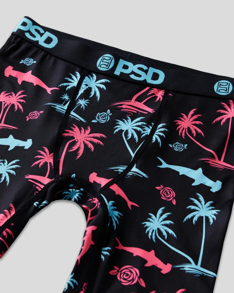 Black PSD underwear with pink sharks, blue palm trees, and circular design elements, featuring PSD waistband branding.