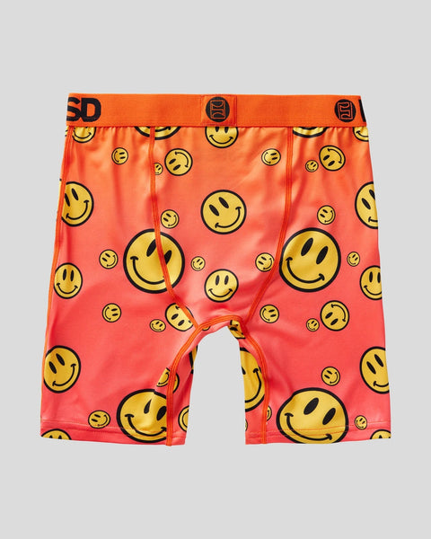 Red boxer shorts with all-over yellow smiley face pattern and orange waistband with black text.