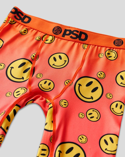 Red and orange briefs with yellow smiley face prints, orange waistband with PSD branding, and red seams.