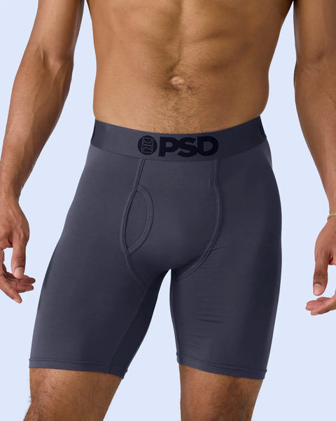 Dark purple-gray boxer briefs with PSD waistband on a shirtless man, shown from waist to mid-thigh.