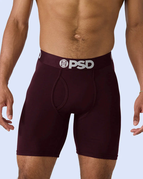 Burgundy boxer briefs with PSD waistband, shown on male model against light blue background.