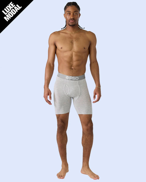 Man wearing heather gray modal boxer briefs with branded waistband.