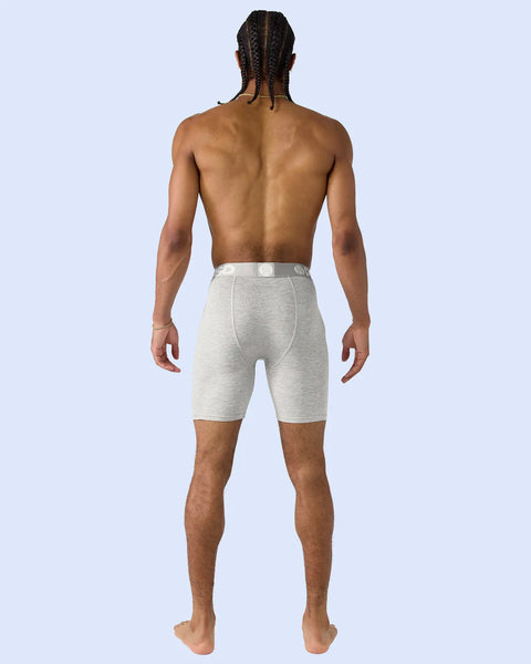 Man wearing heather gray modal shorts with elastic waistband, shown from back view.